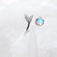 Adjustable ring with dolphin tail made of sterling silver and blue zirconium dioxide